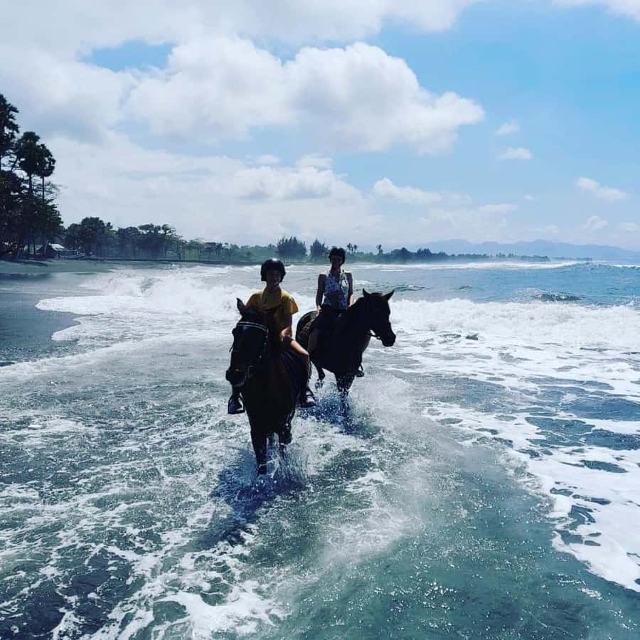 Bali: Horseback Tour Through Saba Beach and Local Temples. - Riding beside the black sand and fishing boats